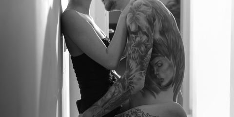 tattooed man and woman having sex