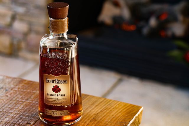 a bottle of four roses bourbon on a table
