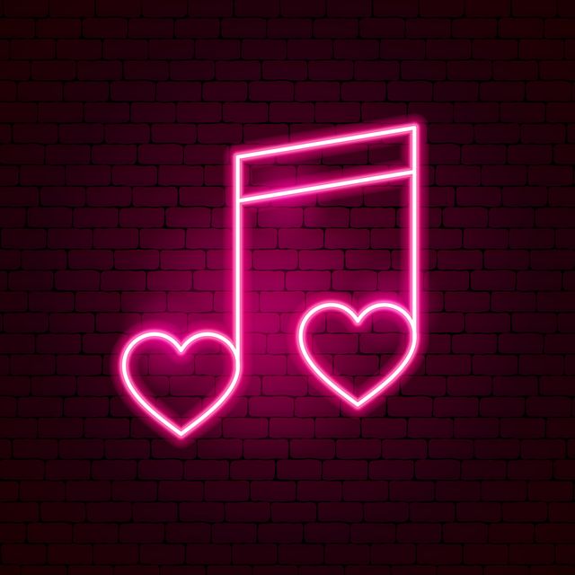 pink neon sign of a sixteenth note with hearts on a brick wall