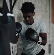 best workout shirts a man boxing at a bag in a gray t shirt