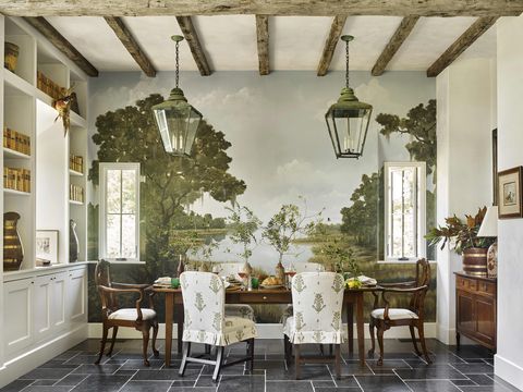 a landscape mural on one wall sets the scene for a wooden dining table and wood and upholstered chairs