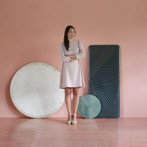 Portrait of Bethan Gray in front of marquetry table tops