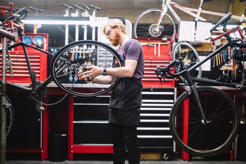 Bicycle Repair Shop and Man Working
