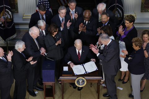 washington, dc   march 15 us president joe biden c is applauded by vice president kamala harris and congressional leaders after signing the “consolidated appropriations act