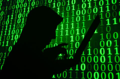 computer hacker silhouette green binary code background