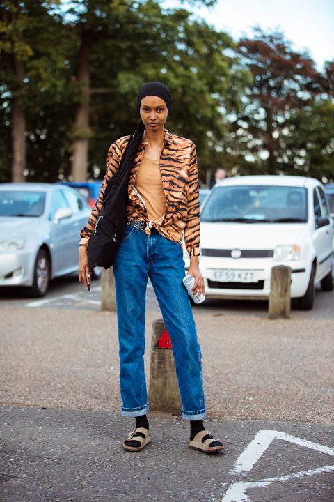 london, england september 15 model ugbad abdi wears a black headscarf, tiger print shirt, blue jeans, black socks, and brown birkenstock sandals after the simone rocha show during london fashion week september 2019 on september 15, 2019 in london, england photo by melodie jenggetty images