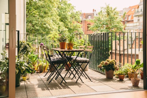 bistro chairs and table on balcony with view in the yard