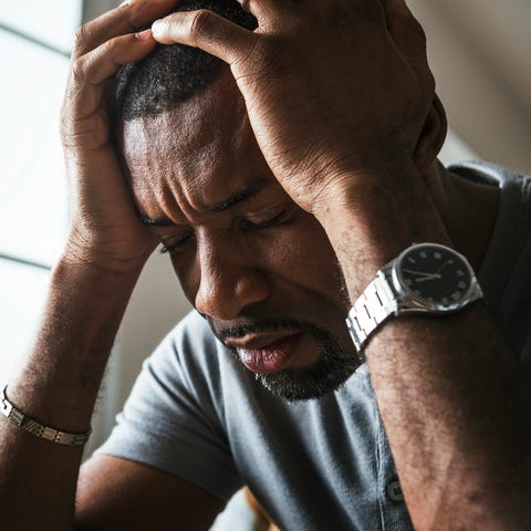 Black guy stressing and headache