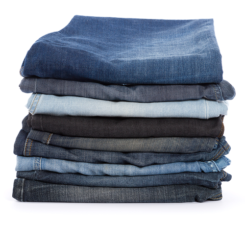 how to stop black jeans fading, featuring an image of dark jeans folded in pile
