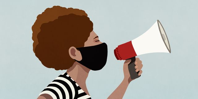 black woman in face mask using megaphone