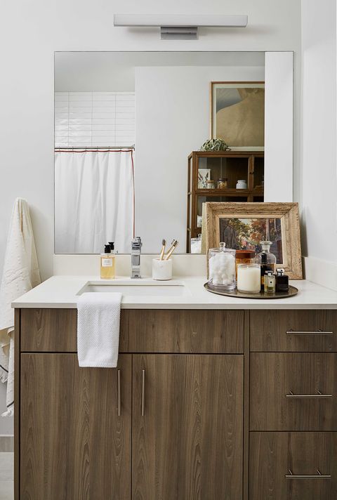 bathroom, white countertop, wooden cabinets