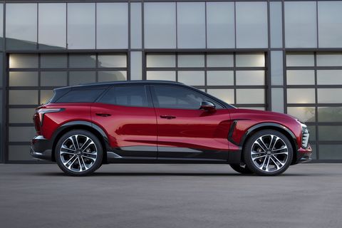 press photo of the chevy blazer ev viewed from the site in front of a glass wall