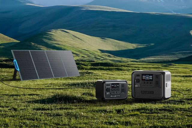 a solar panel on a grassy hill with bluetti portable power stations