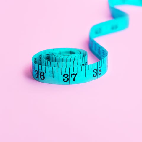 blue measuring tape on pink background