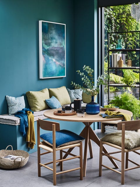 dinning room round wooden table,  dark turquoise wall, sitting area filled with colourful cushions blue artwork hanging on the wallcurl uptreat yourself to some time out and snuggle up in a cosy corner with a pile of squashy cushions andsomething delicious to keep you goinginviting mixpale woods and garden views create a naturally laidback dining space â€“ perfect for friendly gatheringsinviting mixwalls as above bench seat and cushions, as above tweed emphasize scarf in soft blue, Â£80, mourne textiles merino scarf in ochre, Â£70, katie mawson austen oak dining table, Â£495, habitat longworth oak dining chair, Â£170, graham  green oregan dining chair, Â£160, habitat mohair cushion in sage green, Â£4995, bronte by moon design project no157 cushion in teal, Â£50, john lewis  partners carved vase, Â£35 leon round oak tray, Â£35 both john lewis  partners blurred pip hartle mug, Â£35, toast theo french press coffee maker, Â£6495 everyday mugs in charcoal, Â£1095 each all oggetto glacier bowl, Â£55, lucia fraser lario linen napkins in moss and cobalt, Â£36 for four, designers guild seagrass basket, Â£95 for two, cox  cox aurora painting on canvas, Â£650, lucia fraser northcote shelving unit, Â£785, mannmade london carafe glasses in teal, Â£60 for four, nisi living swing stopper bottle in caramel, Â£46, the conran shop
