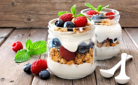 Blueberry, raspberry parfaits in mason jars, still life against wood Blueberry, raspberry parfaits in mason jars, still life against wood