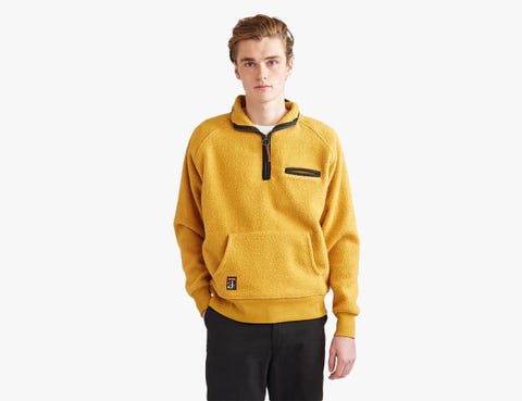 man wearing a yellow half zip fleece