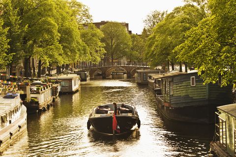 boat along prinsengracht canal, amsterdam, netherlands