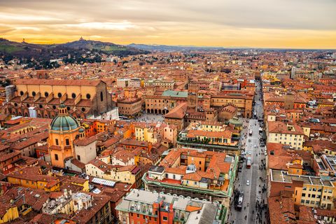 aerial view of bologna, italy at sunset colorful sky over the historical city center with car traffic and old buildings