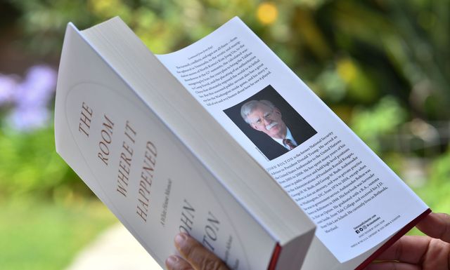 this illustration photo taken on june 23, 2020 in glendale, california, shows a woman reading john bolton's book "the room where it happened" on the day of it's release in los angeles   the trump administration tried unsuccessfully to block publication of bolton's book claiming it contained classified national security informationformer us national security advisor john bolton said sunday he thinks north korean leader kim jong un "gets a huge laugh" over us counterpart donald trump's perception of their relationship bolton spoke to abc news for his first interview ahead of the tuesday release of his tell all book, which contains many damning allegations against trump photo by chris delmas  afp photo by chris delmasafp via getty images