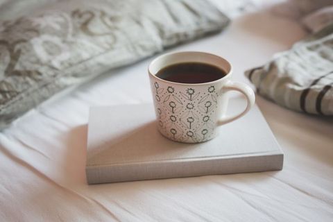 book and cup of black coffee on a bed royalty free image 1626113406