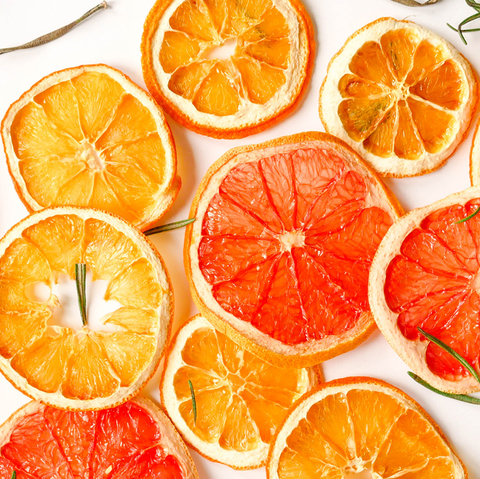 orange slices on a white background, with rosemary sprigs