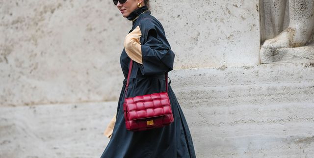 milan, italy   september 24 a guest wears black sunglasses, gold earrings, a gold necklace, a dark gray turtleneck  belted long coat, a beige long sleeves long dress, a burgundy shiny leather cassette shoulder bag from bottega veneta, black shiny leather pointed heels shoes , outside philosophy di lorenzo serafini, during the milan fashion week   womenswear springsummer 2023 on september 24, 2022 in milan, italy photo by edward berthelotgetty images