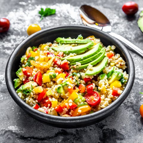 bowl of bulgur salad with bell pepper, tomatoes, avocado, spring onion and parsley