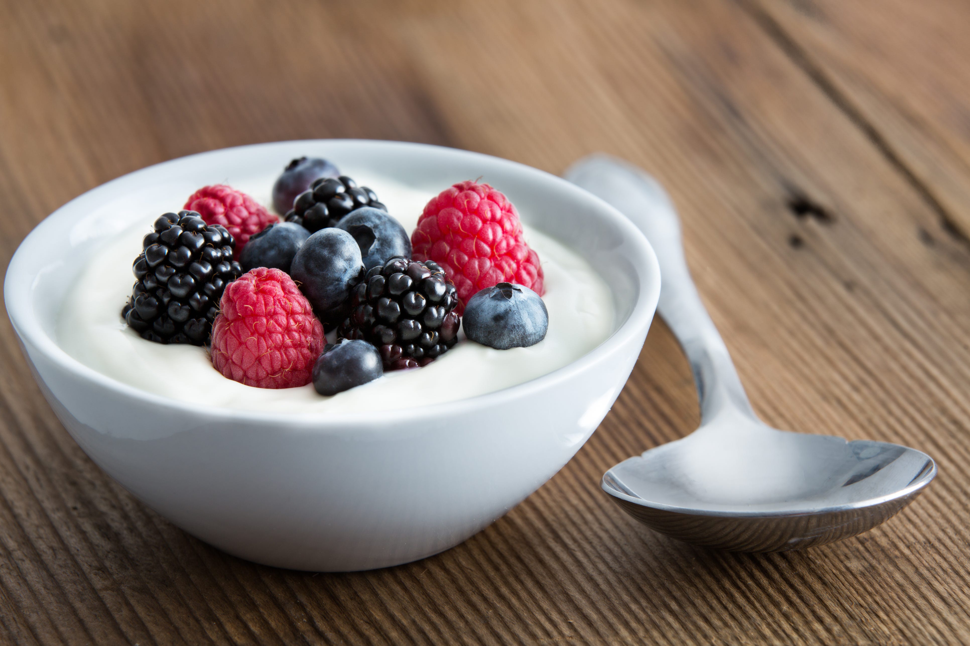  Schüssel mit frischen gemischten Beeren und Joghurt