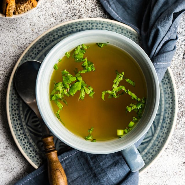 bowl of healthy chicken broth with croutons and parsley