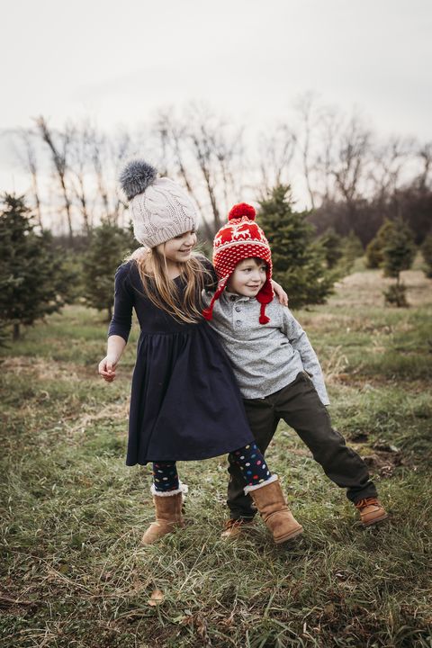 boy and girl siblings at christmas tree farm