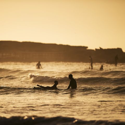 surfers enjoy sunrise at freshwater beach