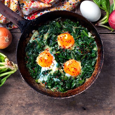 Braised spinach and eggs in an old frying pan