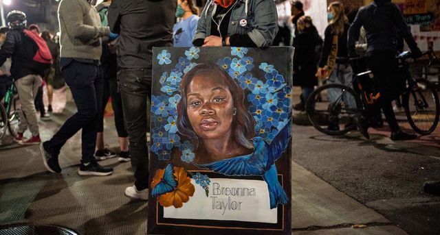 seattle, wa   june 07 a demonstrator holds a painting of breonna taylor during a protest near the seattle police departments east precinct on june 7, 2020 in seattle, washington earlier in the evening, a suspect drove into the crowd of protesters and shot one person, which happened after a day of peaceful protests across the city photo by david rydergetty images