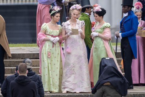 jessica madsen appears to be reading a pamphlet—perhaps something from lady whistledown—on the set of bridgerton season 2