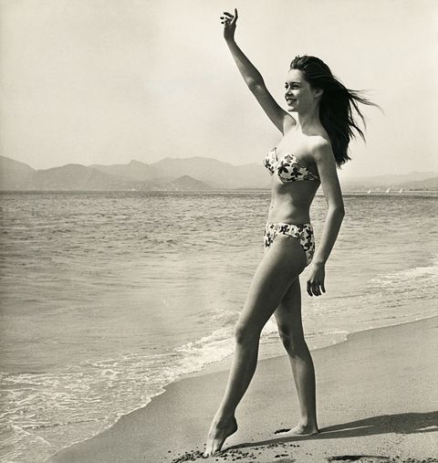 brigitte bardot waving on the beach