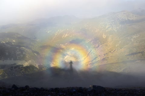 Brocken spectre, shadow of a man on top of a mountain