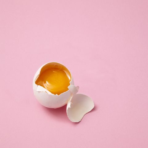 broken egg on pink background