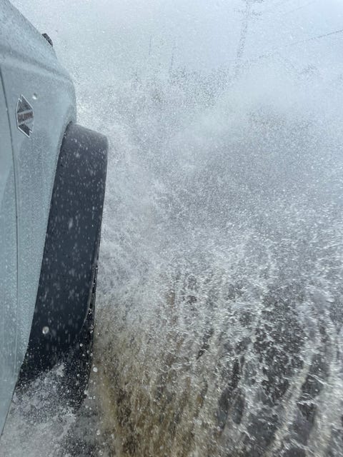 bronco front tire splashing a puddle