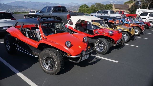 see two generations of meyers manx parked side by side