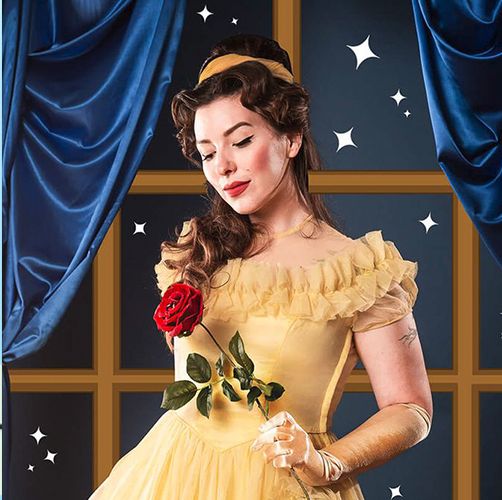 a woman dressed in belle's yellow dress from beauty and the beast