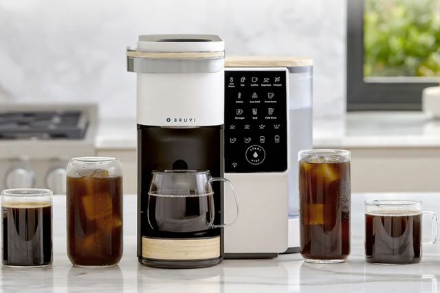 bruvi coffee maker on a counter with coffee cups