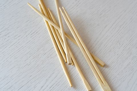 bunch of simple wooden chopsticks flat lay isolated on the table
