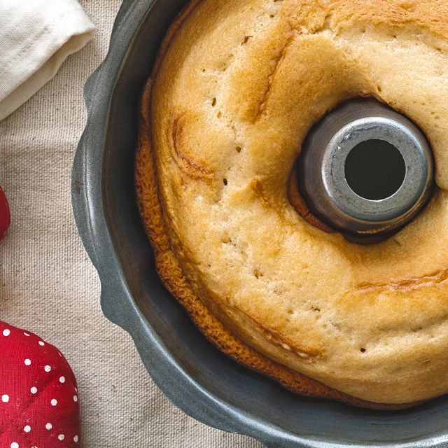 bundt cake pan with flour and red polka dot oven mit