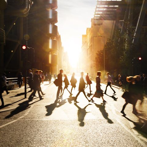 business people walking through at city at dawn