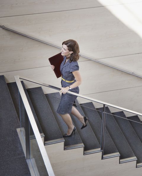 Businesswoman ascending office staircase