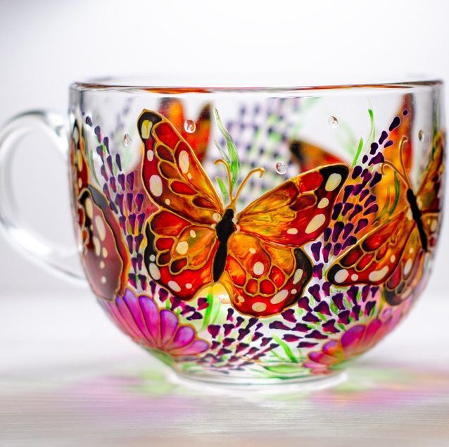 clear glass mug painted with orange monarch butterflies and pink flowers