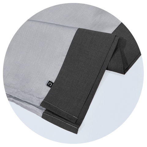light grey and dark grey casper sheets in a white circular graphic frame