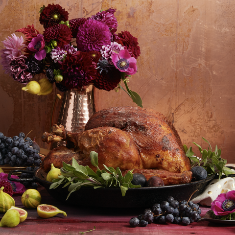cajun spiced turkey on a platter with grapes and figs