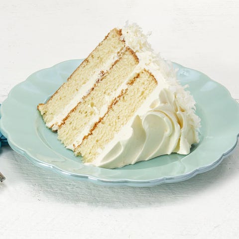 coconut layer cake slice on blue plate